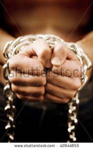 stock-photo-man-s-hands-tied-with-chains-42844855